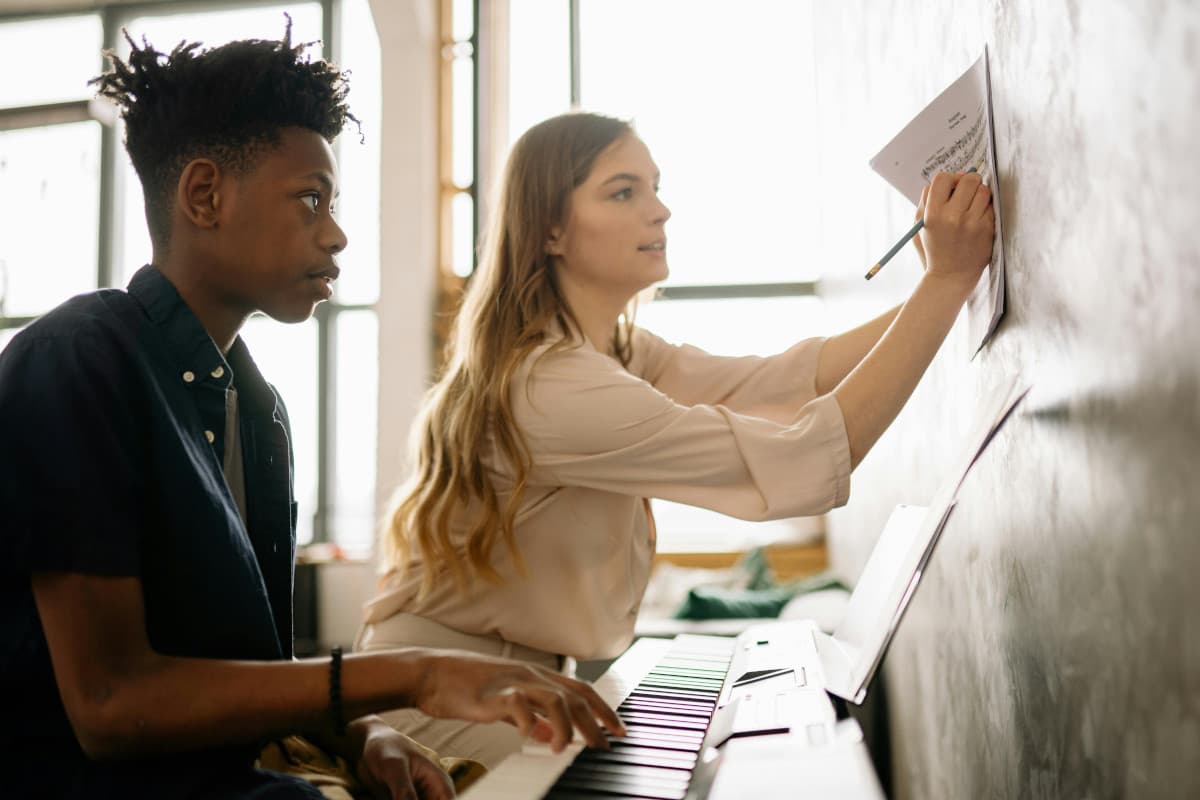 Piano teacher with student